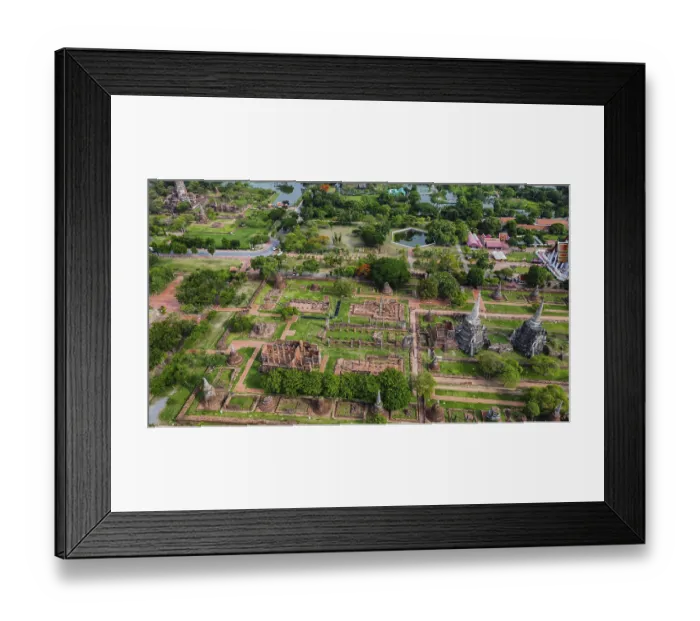 Framed Print : An ancient temple complex next to a city and a modern temple