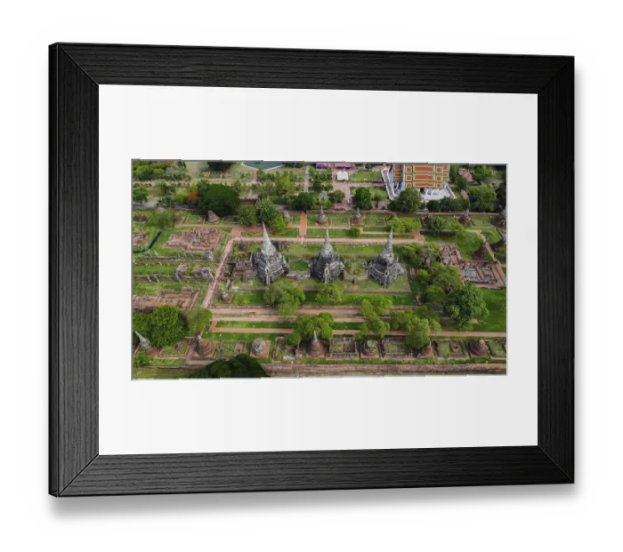 Framed Print : An ancient temple complex next to a city and a modern temple
