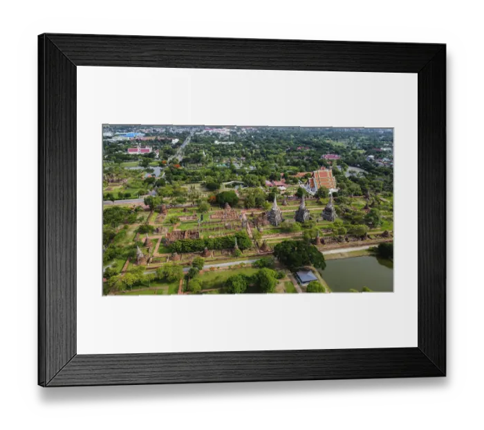 Framed Print : An ancient temple complex next to a city and a modern temple