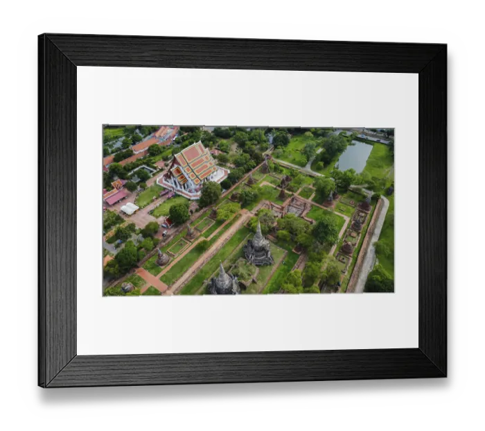 Framed Print : An ancient temple complex next to a city and a modern temple
