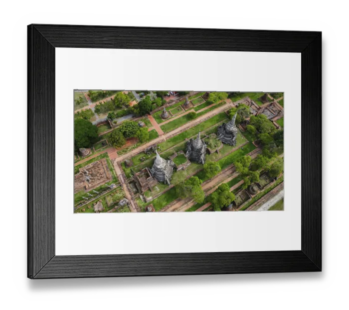Framed Print : An ancient temple complex next to a city and a modern temple