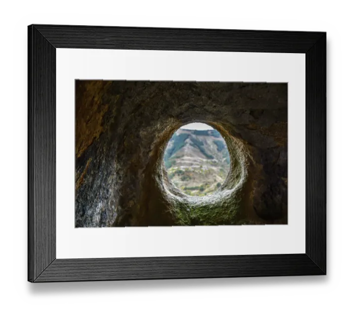 Framed Print : A window in a sandstone cave with a view of the opposite mountain Framed Print : A window in a sandstone cave with a view of the opposite mountain