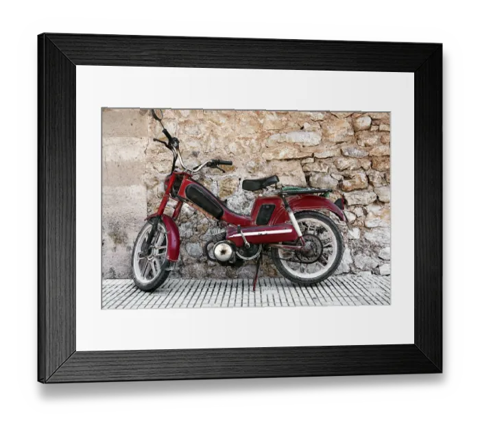 Framed Print : Powered two-wheeler in front of mediterranean wall