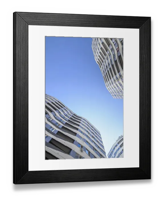 Framed Print : Wide angle shot of new apartments buildings exterior at the background of clear blue sky