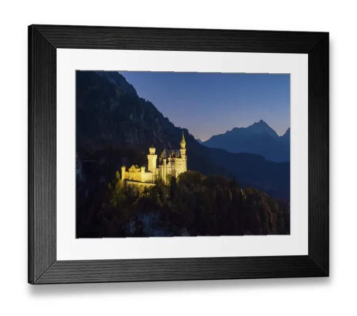 Framed Print : Mysterious view of Neuschwanstein Castle at dusk with mountains in the background