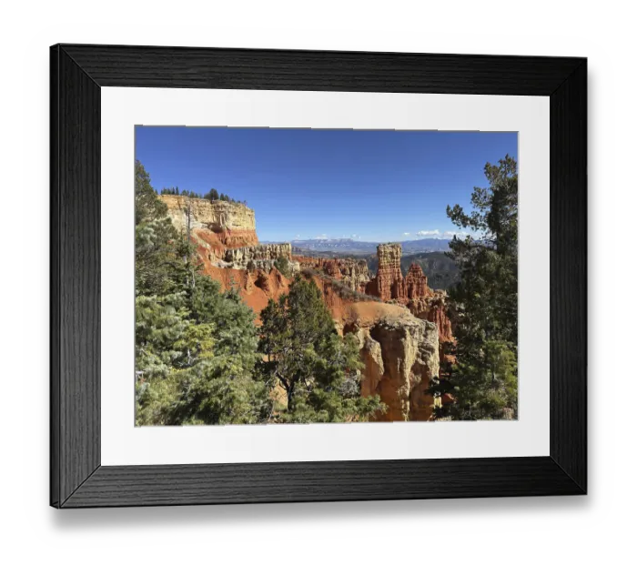 Framed Print : Red cliffs and thick forests stretch to the horizon under deep blue skies