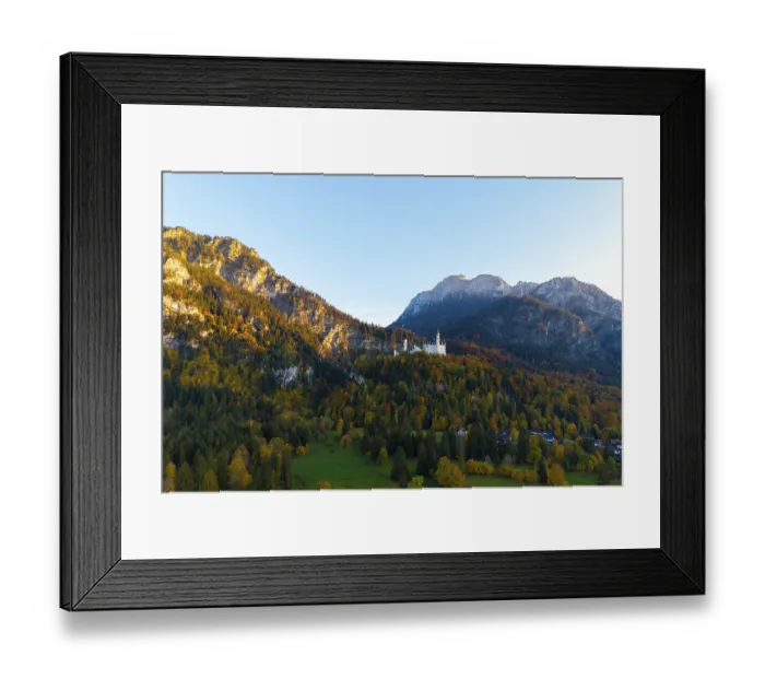 Framed Print : Neuschwanstein Castle perched on a wooded mountain in autumn light with a wide view of the valley Framed Print : Neuschwanstein Castle perched on a wooded mountain in autumn light with a wide view of the valley