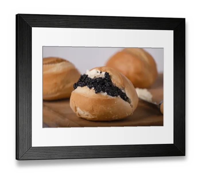Framed Print : One round wheat bun with butter and black caviar