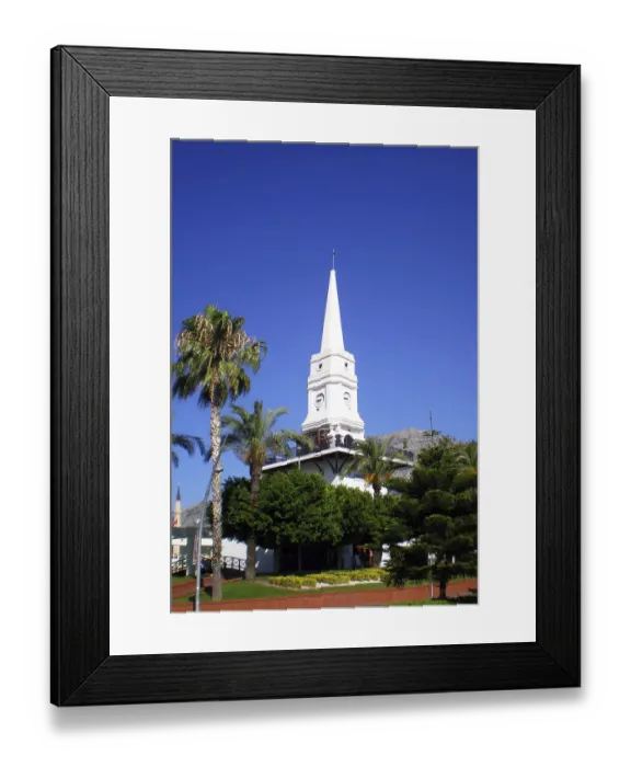 Framed Print : A tall white clock tower surrounded by palm trees