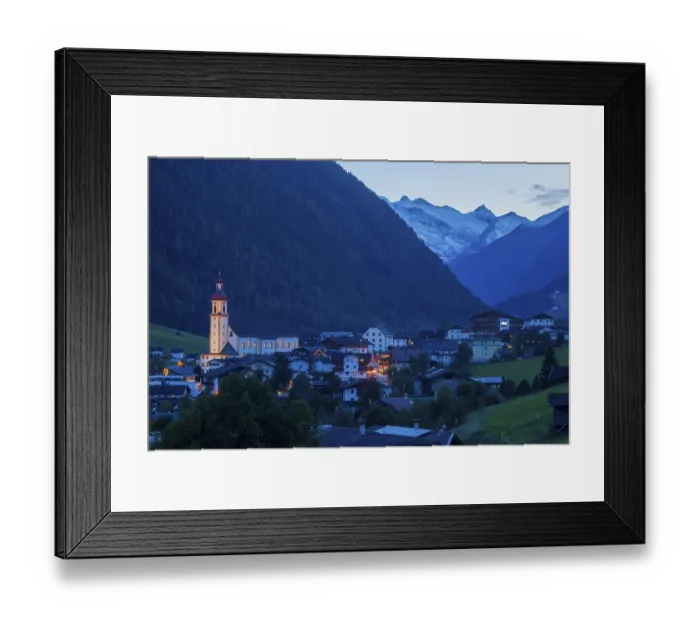Framed Print : View of town with mountains and Stubai glacier at dusk