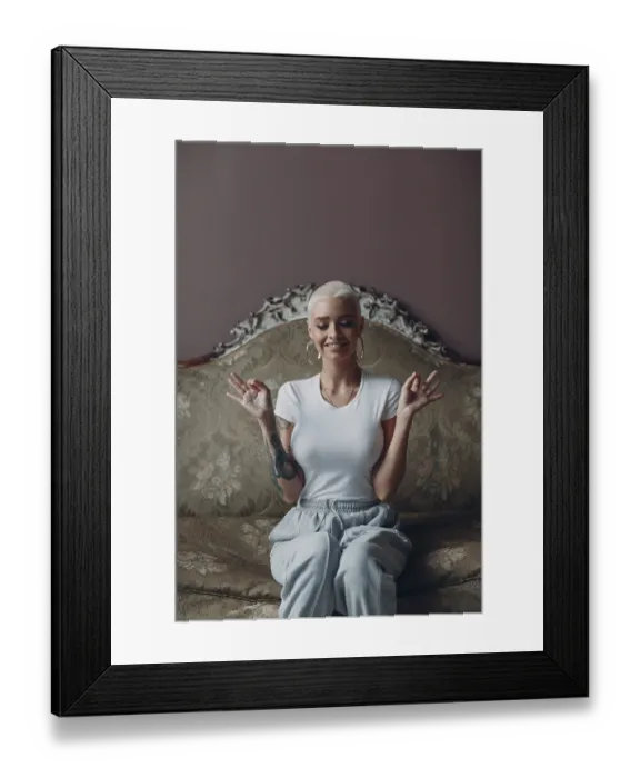 Framed Print : Millenial young woman with short blonde hair portrait sitting and meditate with ok sign mudra on vintage sofa Framed Print : Millenial young woman with short blonde hair portrait sitting and meditate with ok sign mudra on vintage sofa