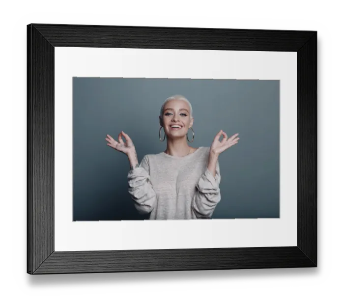 Framed Print : Millenial young woman with short blonde hair portrait sitting and meditate with ok sign mudra on gray blue background