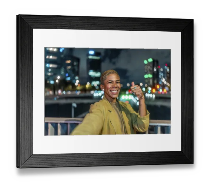 Framed Print : Happy young woman with short blonde hair and a radiant smile is taking a selfie gesture and showing a thumbs up Framed Print : Happy young woman with short blonde hair and a radiant smile is taking a selfie gesture and showing a thumbs up