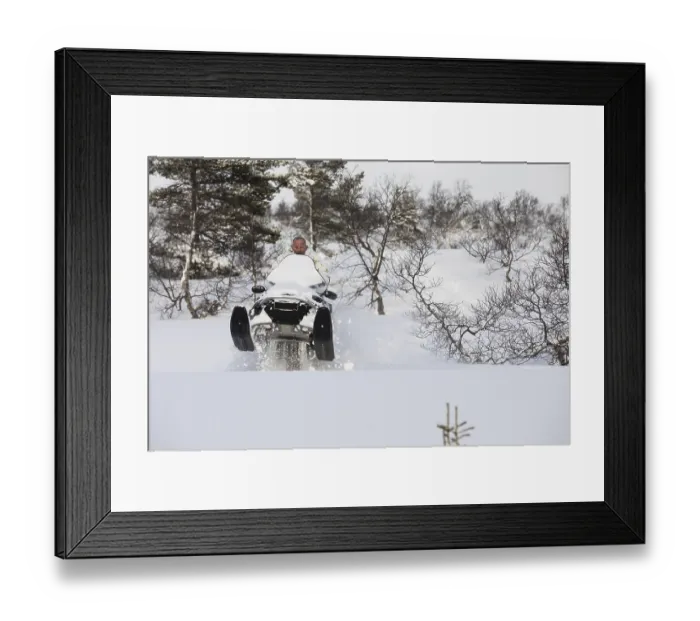 Framed Print : Adult man playing and jumping with a snowmobile in the snow on the mountain in Norway Framed Print : Adult man playing and jumping with a snowmobile in the snow on the mountain in Norway