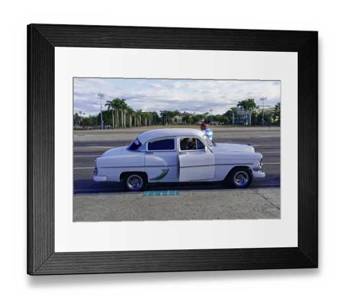 Framed Print : White vintage car in front of palm tree-lined square with people in relaxed surroundings Framed Print : White vintage car in front of palm tree-lined square with people in relaxed surroundings