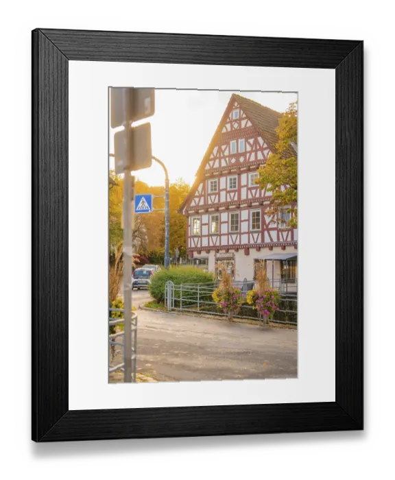 Framed Print : Half-timbered house in autumn surroundings with street lighting and flowers
