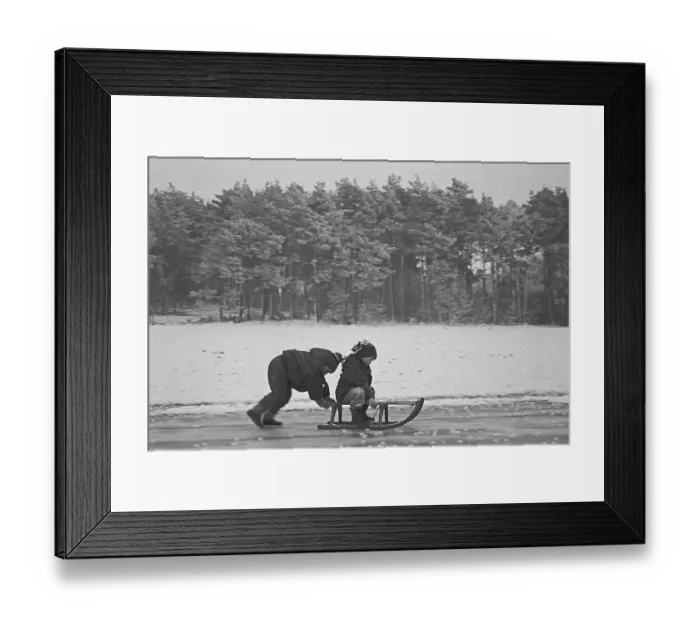 Framed Print : Children ride sledges on ice rink