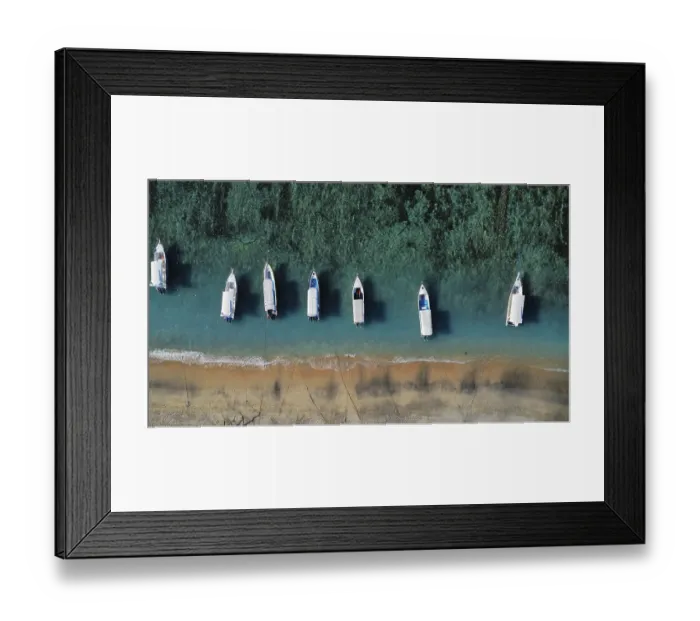 Framed Print : A drone view of an idyllic beach with moored boats in Indonesia