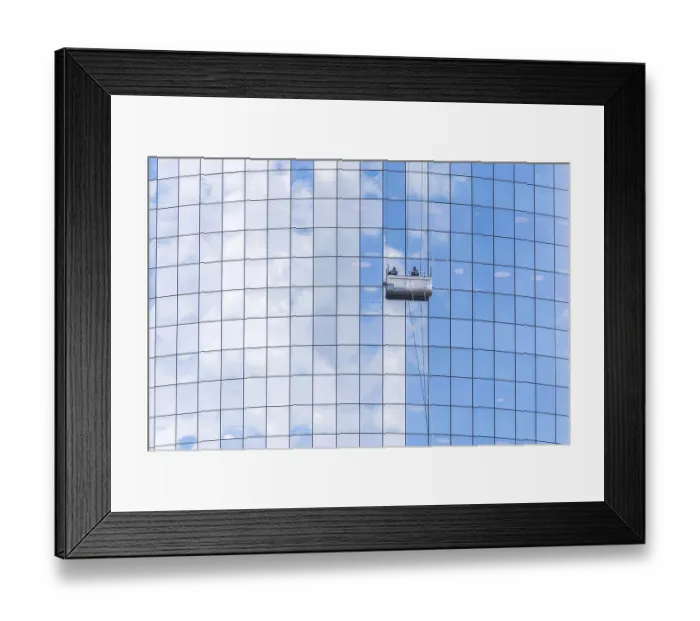 Framed Print : NEW YORK, USA - 16 MAY, 2019: Two cleaners washing the windows of modern skyscraper in New York Framed Print : NEW YORK, USA - 16 MAY, 2019: Two cleaners washing the windows of modern skyscraper in New York