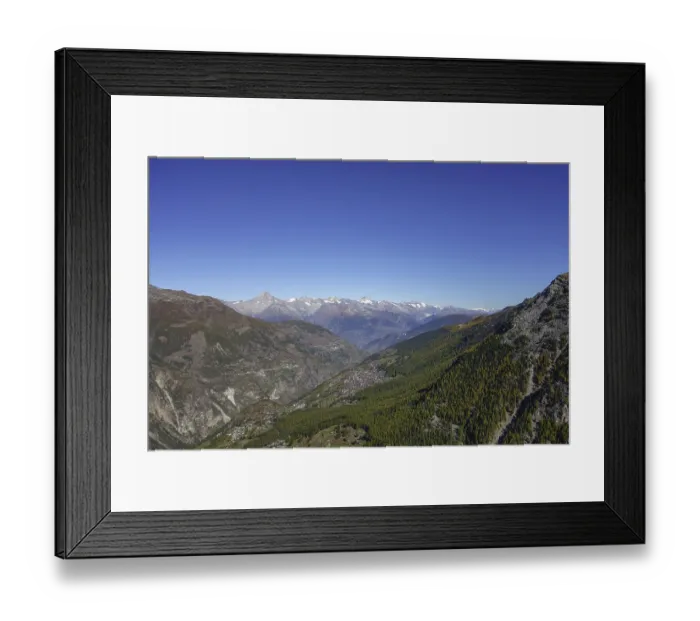 Framed Print : Panoramic view of a valley with mountains and forest under a clear sky