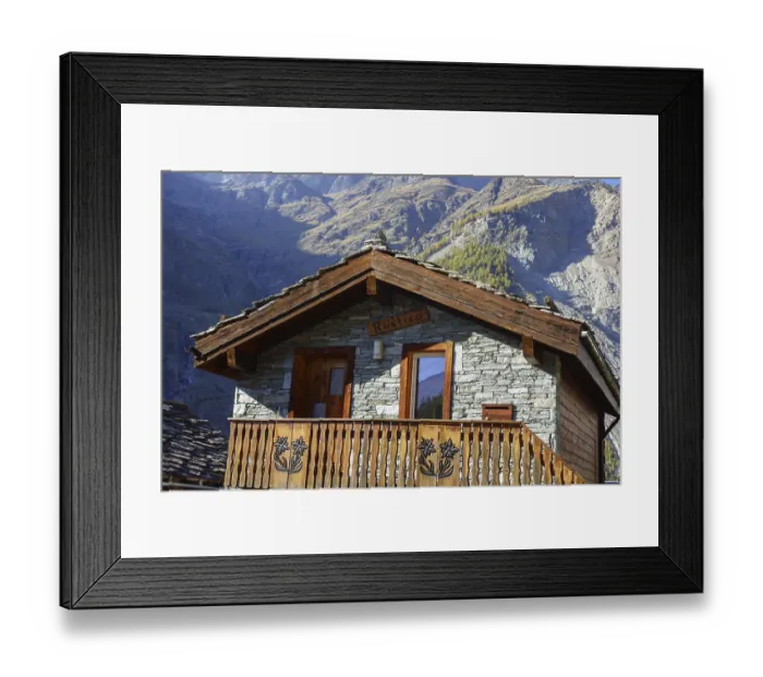 Framed Print : Rustic mountain hut with wooden balcony against an impressive mountain backdrop