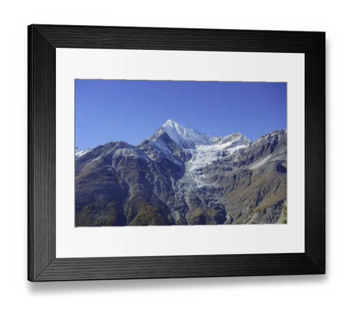 Framed Print : Impressive mountain peak with glacier under bright blue sky