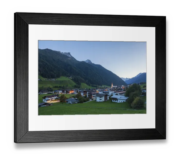 Framed Print : View of town with mountains and Stubai glacier at dusk