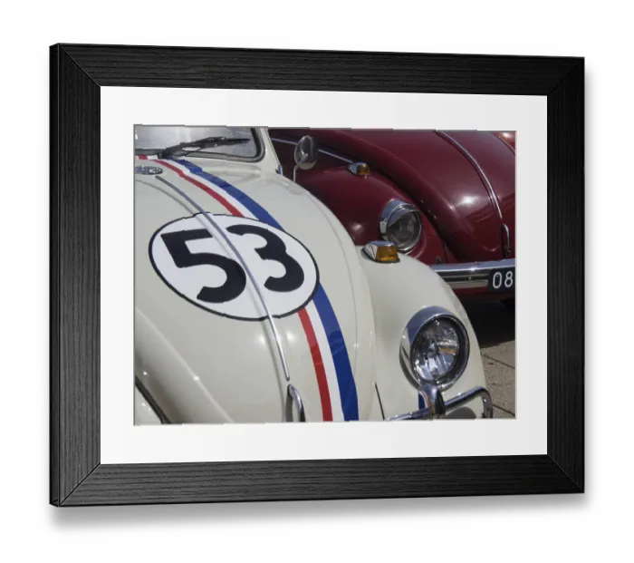 Framed Print : White classic car with racing stripes and number next to a red vehicle