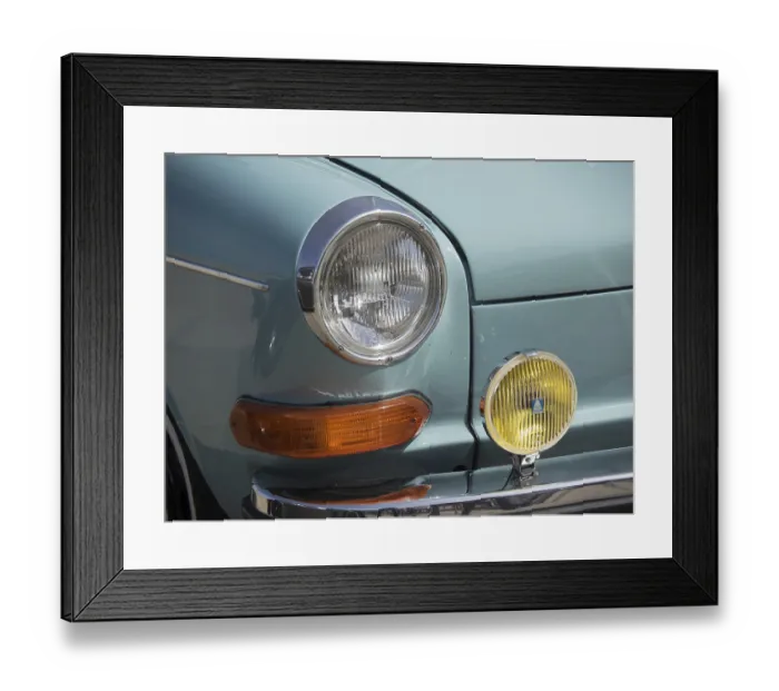 Framed Print : Close-up of the front of a turquoise classic car with orange and yellow headlights Framed Print : Close-up of the front of a turquoise classic car with orange and yellow headlights