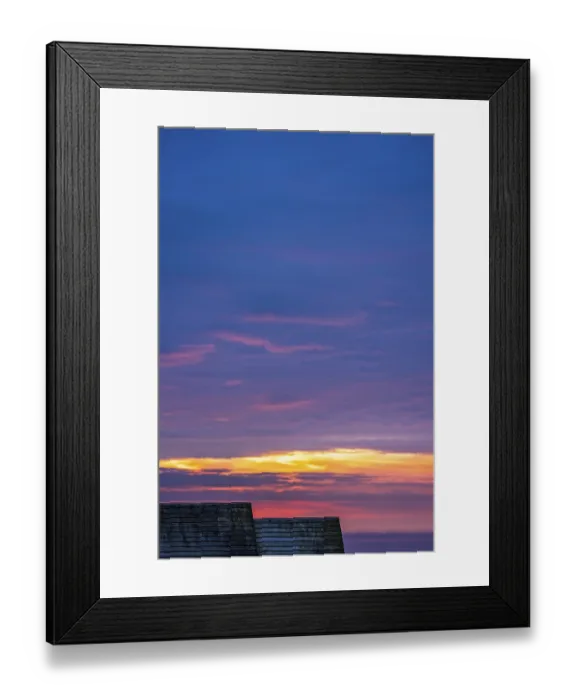 Framed Print : Wooden children playground hut roofs and the beautiful sky at sunset over the Cornish coast