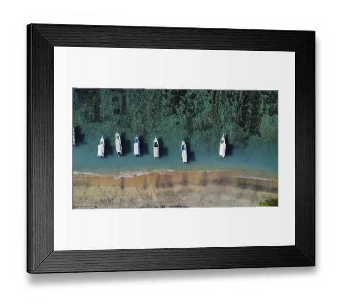 Framed Print : A drone view of an idyllic beach with moored boats in Indonesia