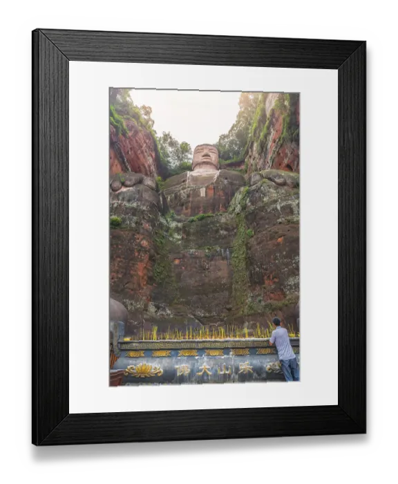Framed Print : Leshan, China - July 2019 : Chinese male pilgrim lightening memorial candles at the bottom of The Giant Leshan Buddha Framed Print : Leshan, China - July 2019 : Chinese male pilgrim lightening memorial candles at the bottom of The Giant Leshan Buddha