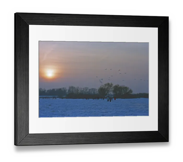 Framed Print : People walk across ice rink, sunset