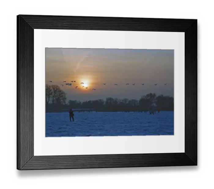 Framed Print : People walk across ice rink, sunset