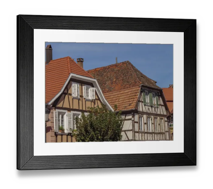 Framed Print : Half-timbered houses with red tile roofs and white shutters on a sunny day