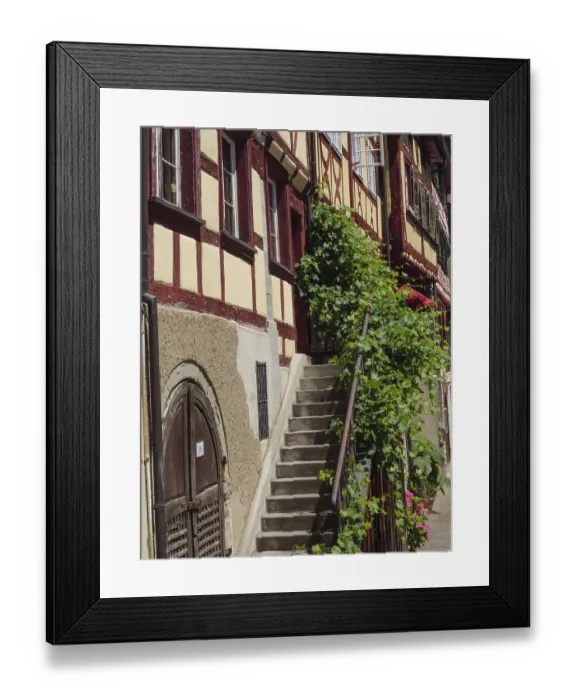 Framed Print : Winding alley with half-timbered buildings