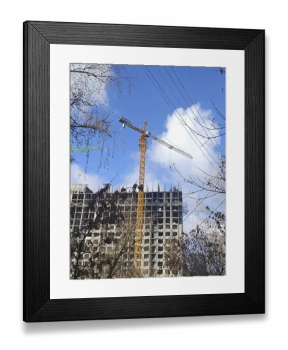 Framed Print : A yellow crane is building a house out of concrete slabs Framed Print : A yellow crane is building a house out of concrete slabs