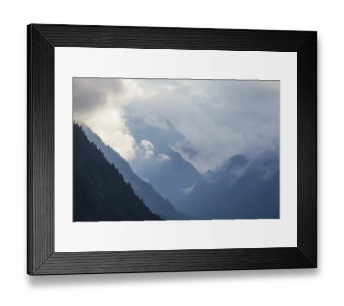 Framed Print : Cloudy atmosphere with forest and mountains