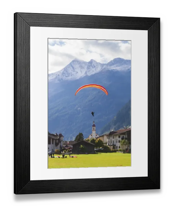 Framed Print : View of town with paraglider, meadow Framed Print : View of town with paraglider, meadow