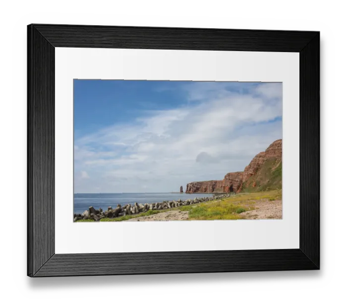 Framed Print : Wide, sunny coastline with concrete tetrapods by the sea Framed Print : Wide, sunny coastline with concrete tetrapods by the sea
