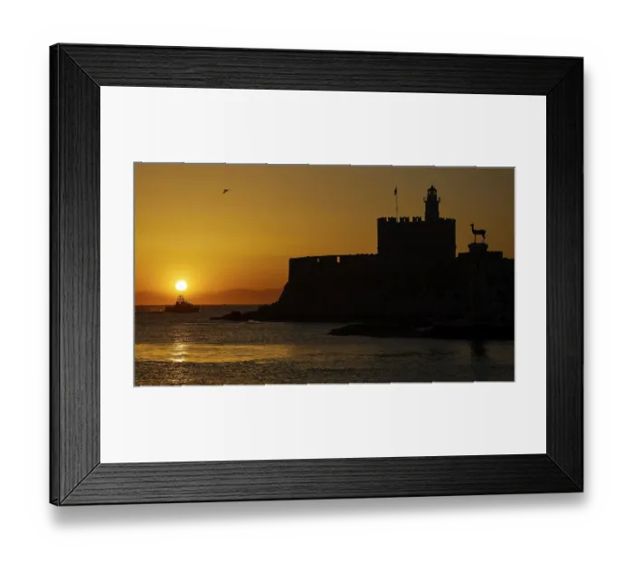 Framed Print : Agios Nikolaos fortress, sunrise over the sea with a castle silhouette and a passing boat