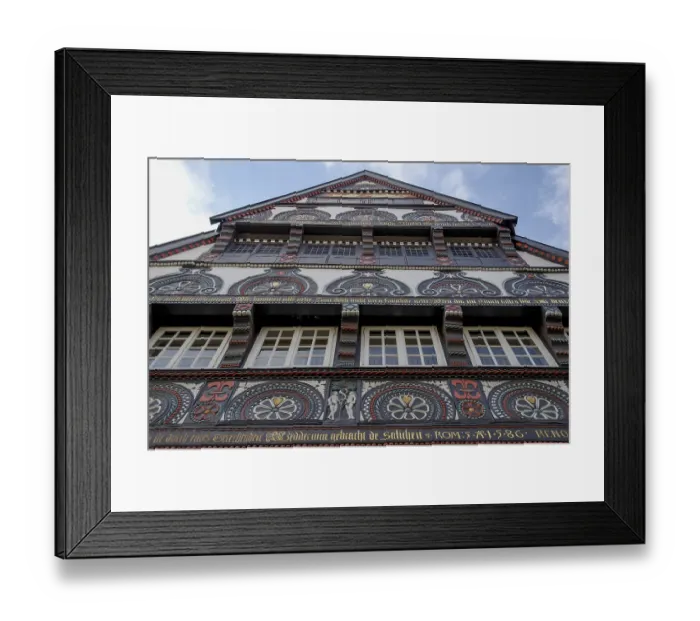 Framed Print : Facade of an artfully decorated historic half-timbered house with rich ornaments and paintings Framed Print : Facade of an artfully decorated historic half-timbered house with rich ornaments and paintings