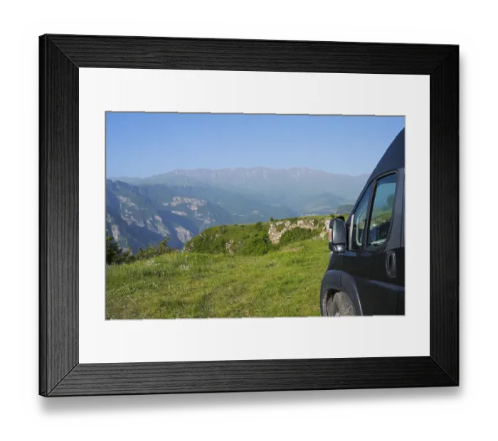 Framed Print : A van stands on a hill with a wide view of a green mountain landscape