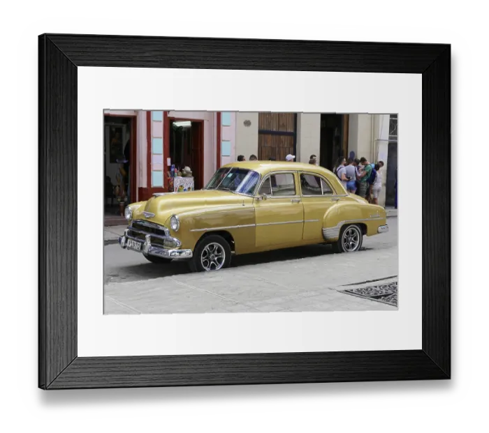 Framed Print : A yellow Chevrolet vintage car stands on an urban street surrounded by historic buildings Framed Print : A yellow Chevrolet vintage car stands on an urban street surrounded by historic buildings