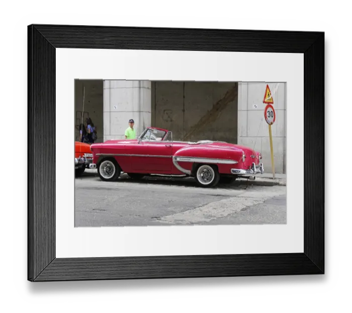 Framed Print : Retro-style red convertible on an urban street with speed sign showing vintage car charm