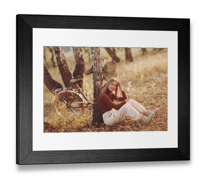 Framed Print : Happy active young woman riding vintage bicycle in autumn park at sunset