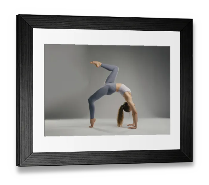 Framed Print : A flexible woman executes a backbend yoga pose