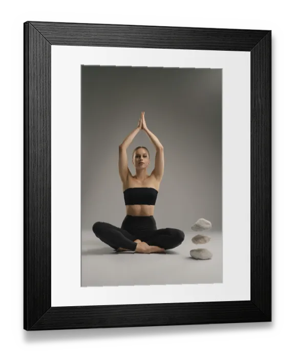 Framed Print : A woman in a black crop top and leggings practices yoga with her hands raised in a tranquil indoor space Framed Print : A woman in a black crop top and leggings practices yoga with her hands raised in a tranquil indoor space