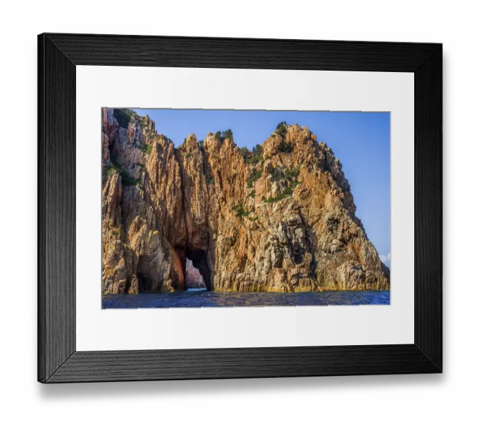 Framed Print : Rock formations and deep blue water in Scandola Nature Reserve