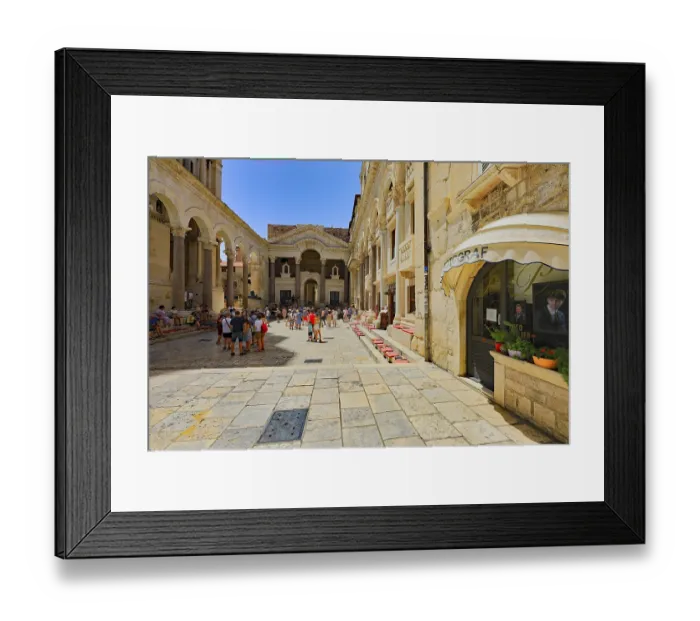Framed Print : Lively historic square with architectural details and visitors